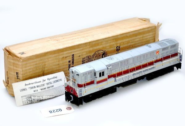 Boxed Lionel 2321 Lackawanna FM Diesel: Gray top, clean, screw cracks, one goes above screw. Battery box is clean. Original box with insert, open both sides and instructions. Otherwise, shows light to moderate playwear, C7