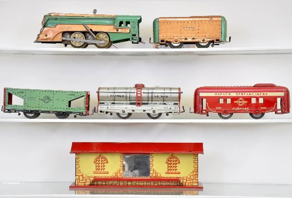 Hafner Freight Train & Station: 1010 steam loco, mechanism functional with bell, tender, hopper, tank car, caboose and freight station. All clean and shiny, shows light to moderate playwear. C7