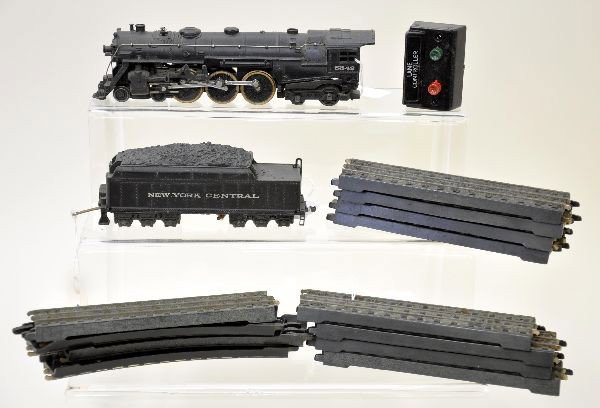 Lionel 002 Hudson Loco with Track: 00 Gauge. 002 semi scale Hudson with 3 brass wheels, 002W tender missing whistle. Includes 9 #0062 straight track and 3 #0061 curves, some track damaged. Trains show light to moderate playwear. C7