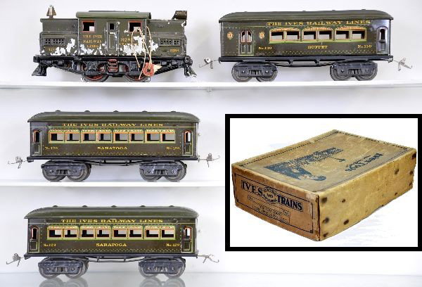 Boxed Ives Train Set: 3253 Electric locomotive, heavy flaking and touched-up; 130 combine; 2 #129 Saratoga coaches. Otherwise, cars show very light playwear, clean and shiny. C8. Original set box has no number.