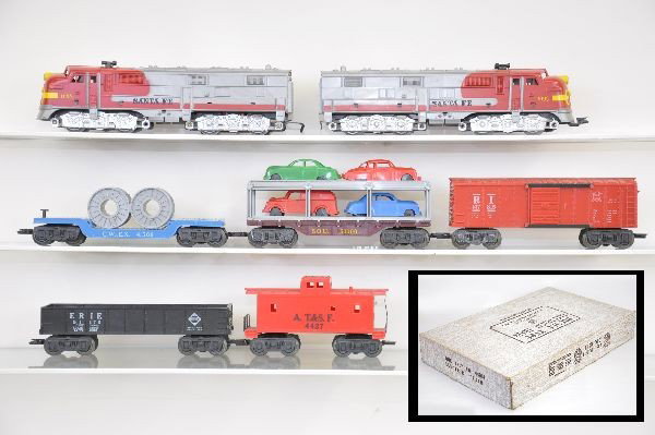 Boxed Marx Set 44914: 1095 Santa Fe E8 AA diesels, power unit has small chip on back. 4566 flat with reels, auto loader, Rock Island box car, gondola, 4427 caboose. Track and transformer, original set box with inserts. Oth