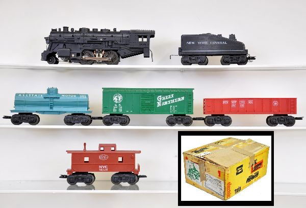 Boxed Marx Allstate Set 9714: 1666 steam loco with smoking cylinders, slope back tender, tank car, boxcar, gondola, caboose, trestle set, plastic accessories, package load for gondola, track and transformer. Original set box with