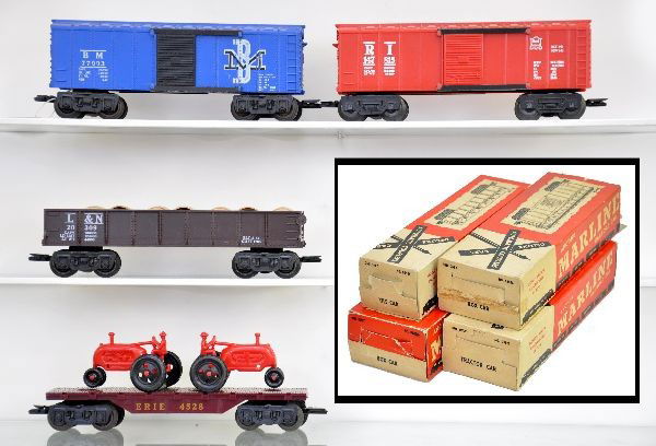 Boxed Marx Rolling Stock: #05536 L&N tile car with load; 05555 B&M royal blue box car; 5555 RI red box car (on E trucks); 05521 tractor car with load. All have original boxes. Cars show very light playwear to like new. C8-9