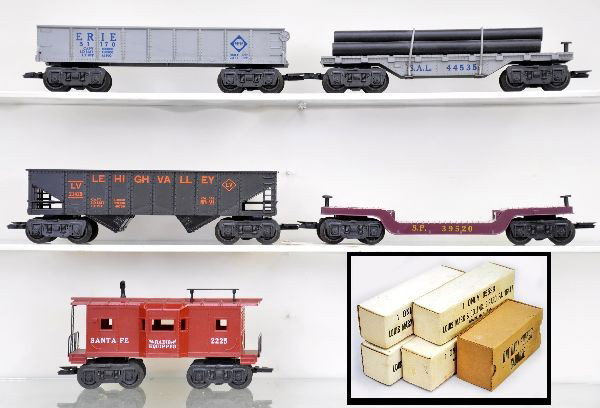 Boxed Marx Rolling Stock: 5554 LV hopper, 5572/2 silver gondola, 5538 well type flat car, 5596 Santa Fe bay window caboose, complete and scarce 5535 SAL pipe flat with plastic pipes. All unrun, original boxes, factory new. C9