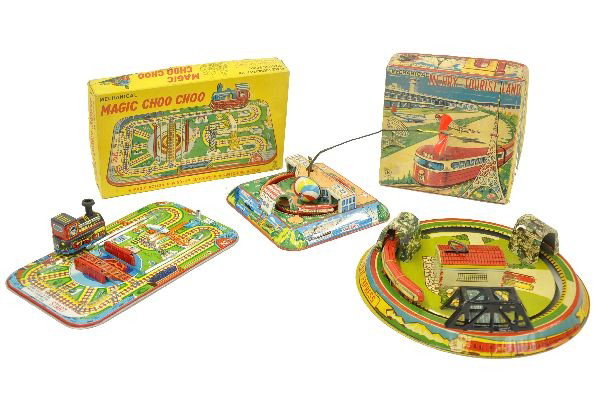 Tin Train Toy Lot: K Japan Merry Tourist Land platform toy, mechanism functional with original airplane; TPS Magic Choo Choo platform toy, mechanism functional. Both are boxed with inserts, factory new C9-10; Marx Honey