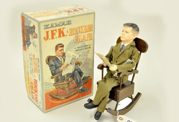 Scarce Boxed Kamar JFK in Rocking Chair: Scarce toy, vinyl and wood, mechanism functional with music box and rocking motion. Original store tag and newspaper. Clean original box, toy is factory new C9