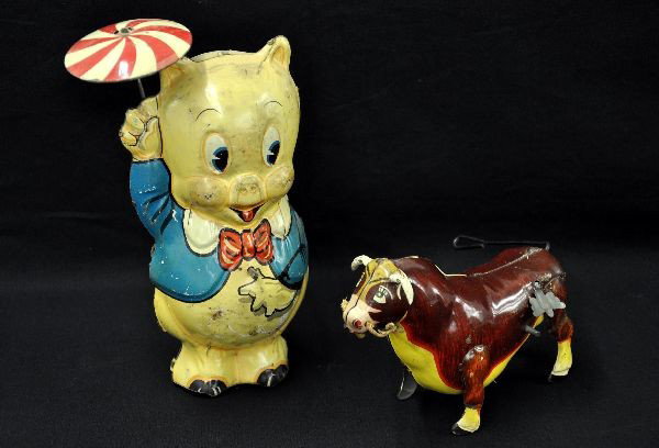 Marx Disney's Porky Pig and Ferdinand: Early Porky Pig with umbrella vibrating toy, 8" tall, litho tin, dated 1939; Ferdinand the Bull with original rose and butterfly, both mechanisms functional. Both show light to moderate playwear, but 