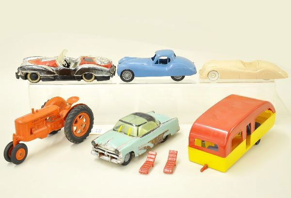 Plastic Toy Vehicle Lot: 8 1/2" Case tractor, 8 1/2" Jaguar convertible, 8" Ideal Jaguar coupe (missing hood latch), 9" Irwin Cadillac with operating windshield wipers (C5), 10" sports car (C4), unusual 9 1/2" house trailer w