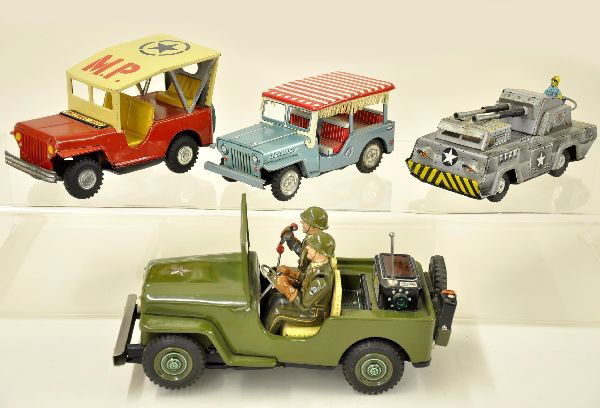 Tin Vehicle Lot: TN Japan, 11 1/2" Military Jeep, battery operated with mystery action, figure answering phone and crackling radio; 8" Military Police Jeep; 7" Surry Jeep; K Japan 7 " Military vehicle with guns which
