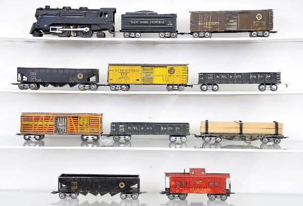 Marx Scale Freight Set: 397 loco, wedge tender, NYC gondola, B&M lumber car, 2 LNE hoppers, Santa Fe stock car with brown doors, PFE reefer, Penn boxcar, Reading caboose. All show light to moderate playwear, C7