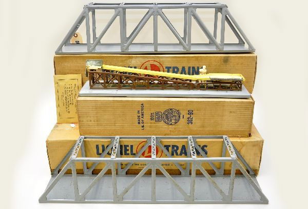 Boxed Lionel Accessories: Two #317 trestle bridges, one has one bent cross brace; 362 barrel loader, missing load. All have original boxes. Accessories show moderate playwear. C6