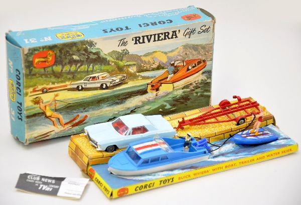 Boxed Corgi Gift Set #31: Buick Riviera, Dolphin 20 cabin cruiser, Evinrude outboard motor, Brooklands trailer water skier. Complete and original, minor age spots on boat decal. Original box with display inserts and coupon. Li
