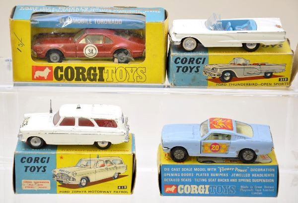 Boxed Corgi Vehicles: 215 Ford Thunderbird convertible, blue interior; 419 Ford Zypher police wagon; 348 Ford Mustang Flower Power, missing hood decal; 276 Oldsmobile Toronado. All have worn original boxes and show moderat