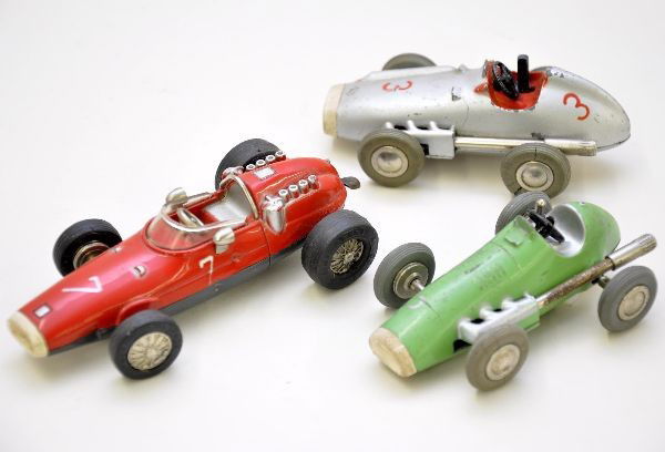 Schuco Micro Racer Lot: 1040 and 1043 Grand Prix racers. Both mechanisms functional. 1040/1 Ferrari, mechanism functional but missing the steering grab handle. All show light to moderate playwear, C7