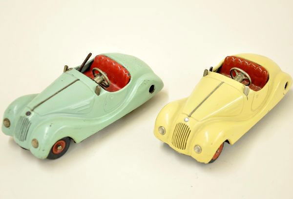 Turquoise and Cream Schuco 2002 Cars: Both are Akusticos. Cream colored car has both mechanisms functioning, though drive slips slightly. Turquoise car drive functions, horn does not. Both vehicles are missing wind screens and show light