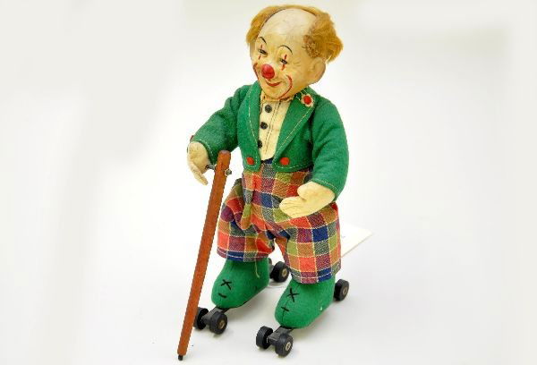 Scarce Schuco-Rolly Clown: US Zone Germany, 8" tall, composition head shows age cracking, mechanism functional, cloth is unusually clean. Toy shows light to moderate playwear. C7