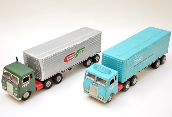 Two Tractor Trailer Vehicles: Both litho tin, 16" long. White Freightliner cab over pulling a Canadian Freightways trailer, missing one door. Cab over, Sears tractor trailer. Both show moderate playwear, C7