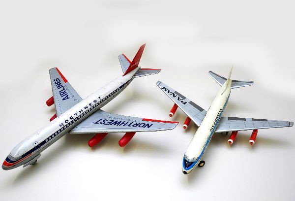 Northwest & Pan Am DC707 Jet Planes: Both are litho tin battery operated. Pan Am version is made by Alps and shows light playwear, C8. Northwest version is imported by Cragstan and has a 12" wing span and shows moderate playwear, C6+