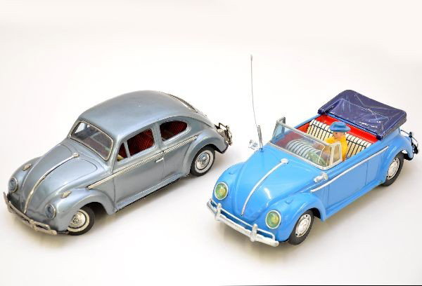 VW Beetle Toy Cars: Both are Japanese litho tin examples and are 8 1/2" long. They appear to be early 1960s models and are nicely detailed. Both are operational with lights and mystery action. The blue car is marked Mode