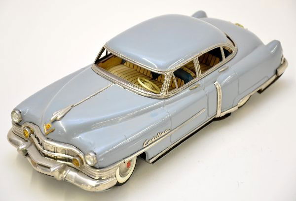 1953 Marusan Cadillac Sedan DeVille: Litho tin, 12" long, missing tail lights and one rear bumper guard. Clean and shiny, a super model. Otherwise, shows light playwear, C8
