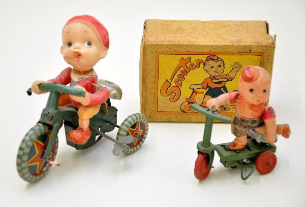 Early Celluloid Toys: Boxed Alps Scooter, 3 1/2" Long, mechanism functions with nice celluloid boy and scarce original box; 5 1/2" boy on tricycle, litho tin with celluloid figure, chin is dented and stringing is a bit loo