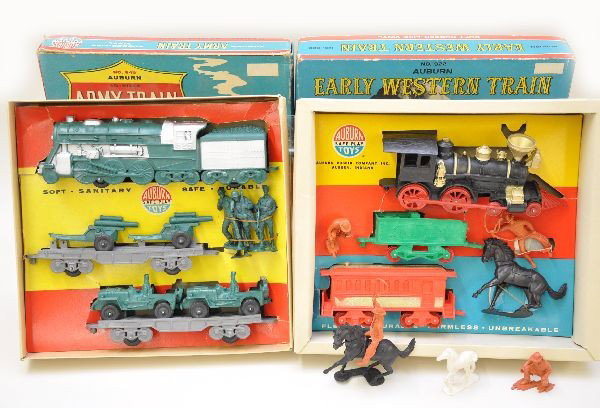 Unusual Boxed Auburn Rubber Train Sets: 922 Early Western train and 945 Army train. Both are complete with display inserts. Original boxes show light wear, sets are like new, C8+