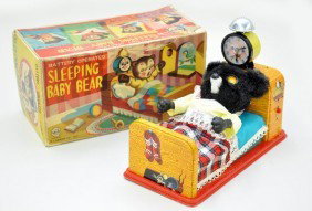Boxed Marx Sleeping Baby Bear: Very Cute toy! Litho tin and plush, battery operated. Clock rings, bear opens eyes, sits up and yawns, squeaks, then returns all fictional. Toy shows light to moderate playwear with original box, C7