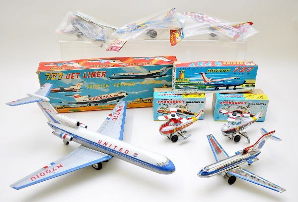 Boxed Airplane and Helicopter Lot: Two 9 1/2" Lucky Toy jets, sealed in bags; 7" navy fighter, sealed in bag; Hero Toy fire and police helicopters; Marusyo 16" wing span; United Air Lines 727; TT Japan, Pan Am 727. All are like new wit