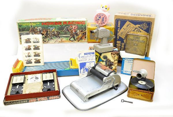 Miscellaneous Toy Lot: Two Bing Pigmy phones, 5 1/2" square record players, one is complete and nice, other shows wear, functional but incomplete; Boxed Cragstan movie projector with cavalcade of stars, instructions; Irwin