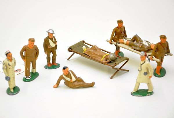 11 pc Dimestore Medical Lot: Field surgeon and nurse; wounded on crutches; walking wounded; stretcher bearer set with wounded; wounded on cot; and wounded leaning. Various conditions C6-8