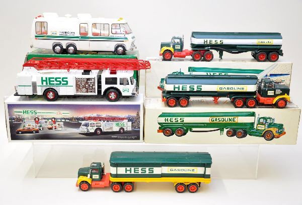 Four Early Hess Trucks Plus: 1968-69 Marx split window tank truck, missing one mirror, includes original box with one insert; 1977 Amerada tank truck, cracked top horn, and a little dirty, 1968 box with one insert; 1975 box truck