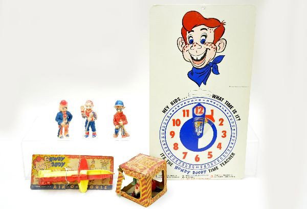 Early Howdy Doody Toy Lot: Boxed plastic Flub-A-Dub, three Howdy Doody hard plastic 4" figures with movable mouths; scarce Air-O-Doodle on worn card; Unusual Howdy Doody time teacher board. All show light playwear. C7+-8