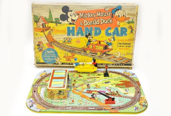 Boxed Marx Mickey Mouse & Donald Hand Car Set: Litho tin and plastic, platform measures 21 x 13", hand car mechanism is functional, Donald figure has been repaired at feet. Rough original box, otherwise, shows light to moderate playwear, C7
