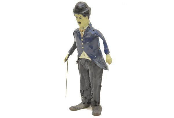 Guntherman Charlie Chaplin Toy: Litho tin with cast iron feet, 8" tall, mechanism functional, original arms and cane. Shows light to moderate playwear. C7