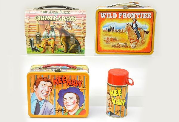 Three Western Themed Lunch Boxes: Ohio Art 1977 Wild Frontier, light oxidation inside; King-Seeley 1971 Hee Haw with original metal thermos, like new; Aladdin Industries 1977 Grizzly Adams dome lunch box. Otherwise, boxes show light w