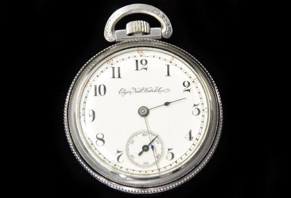 Elgin Pocket Watch: Marked on face Elgin National Watch Company, porcelain face with red and black numbers, silver metal case marked Defiance No. 7319677, movement marked GM Wheeler, Serial No. 3266122, mechanism functio