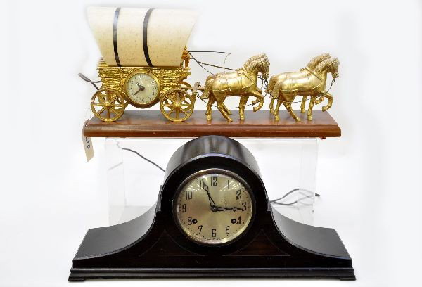 New Haven & United Mantel Clocks: New Haven 20" mantel clock, mahogany case with inlay, plating on face shows wear, mechanism functions; United animated conestoga wagon clock, electric with moving hand with whip, 20" long. (NETTE does