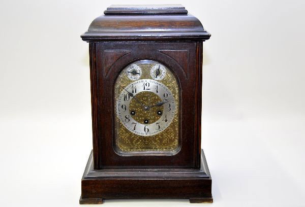 Unghans Mantel Clock: Germany, 12" X 9" X 17", walnut case with brass face. Mechanism works with pendulum & key, nice chime. Case shows some wear, but should clean up nicely. (NETTE doesn't guarantee that clocks will keep 