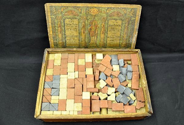 Early Anchor Stone Block Set: By Richter, New York. Patented 1900. Set appears fairly complete and includes original wooden box, cover label is intact and aged fairly dark, top slide is missing a 6" section but still closes. 14" x