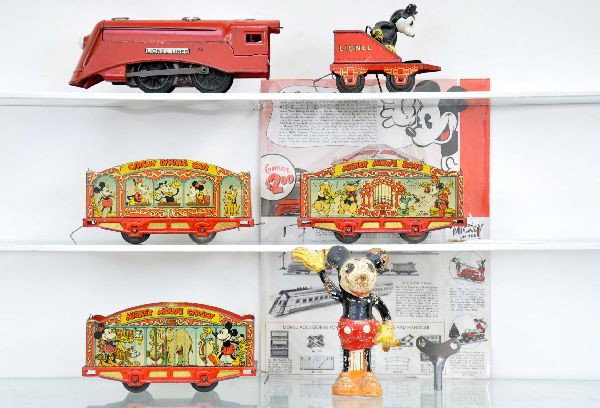 Complete Lionel Mickey Mouse Circus Set: 1509 Vanderbilt locomotive with battery light, mechanism functional with key but needs lubrication; 1506M Mickey Mouse stoker tender, nice figure paint; dining car; cage wagon; band car. Original pamp