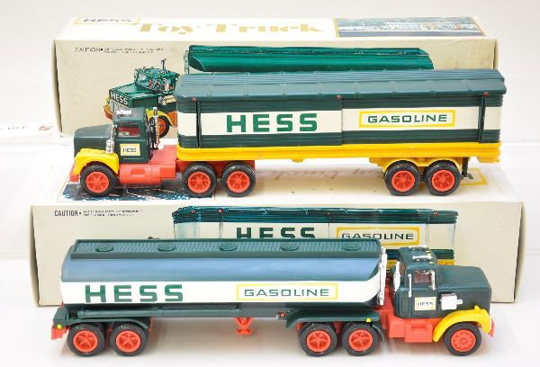 Two Early Hess Trucks: 1975 Boxed tractor and trailer with 3 barrels, original box with one insert; 1977 tank truck, mint in the box, with instructions and inserts. Original box tops show some yellowing, but trucks are C8-9