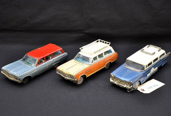 Three Tin Station Wagons: Bandai 8" Buick wagon, luggage rack has airport limousine signs, battery operated, forward and reverse is functional, shows light playwear, C8; 9" Ford estate wagon with airport limousine plates on si