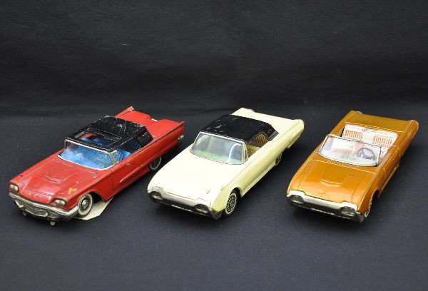 3 Bandai Ford Thunderbird Tin Cars: Each is 8" long, litho tin with rubber wheels. 1961 hard top and convertible. The convertible has small split in windshield frame, otherwise shows light playwear, C7+; 1958 Square Bird with sun roof, 