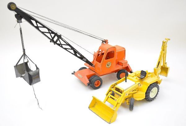 Two Construction Toys, Ny-Lint & True Scale: True Scale International backhoe, painted diecast, approximately 20" long, showing moderate playwear, C6+; Doepke unit crane, complete with nice decals and out riggers. Shows light playwear, C7+.