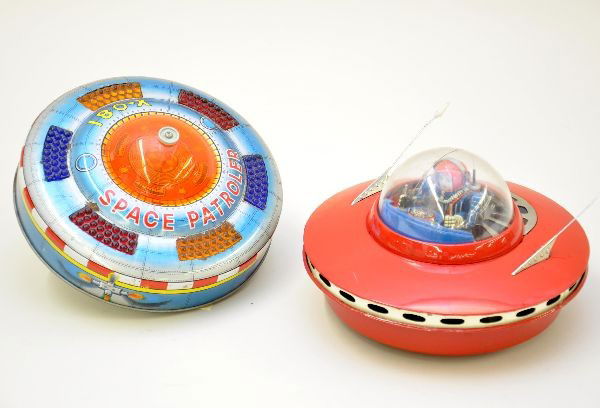2 Flying Saucer Battery Toys: KO Japan Space Patroller, 7" across, mechanism functional, bump and go action, stops and raises up on side and spins; Explorer Spaceship, 8" across, 1950s toy, mystery action with red/blue spinning li