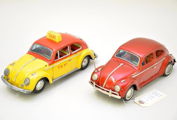 2 Unusual Japanese Tin VW Beetle Cars: Both are 10 1/2" long and battery operated. Both mechanisms are functional. Bandai red early 1960s Volkswagen Bug, exposed engine with driver, mystery action, lighted and animated motor, shows light p