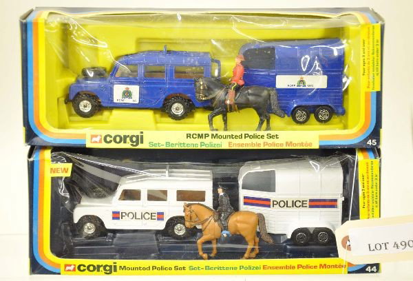 Boxed Corgi Police Sets 44 & 45: 2 Different Land Rovers, horse trailers and mounted officers, One is US other is Canada. Vehicles are mint, boxes show minor wear with inserts. C9