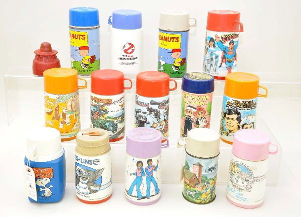 14 pc. Assorted Thermoses Plus: Assortment of thermoses including: Donny & Marie, Dino-Riders, The Fox and the Hound, Snoopy, 1959 metal Peanuts, Gremlins, Transformers, Raggedy Ann and Andy, My Little Pony, Buck Rogers, Superman, G