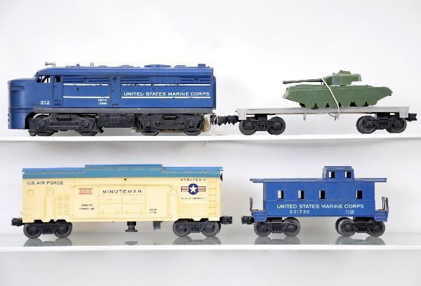 4 pc. Lionel Space Set: 212 USMC Alco A diesel; 3665 Minuteman Launcher, light blue roof, car is faded, missing missile; 6401 flat with green tank; 6017-50 USMC caboose. All show moderate playwear, C6- The auction containing
