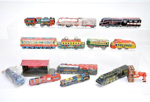 14 pc. Tin Toy Train Lot: Occupied Japan Billy Boy baggage carrier, mechanism functional 3" long; four 8" Japanese steam locos; three 6" Japanese tin steam locos; 5" loco, sealed in bag; 5 1/2" electric loco; 7 1/2" comic inte